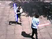 Rob and JohnB fighting with light sabers